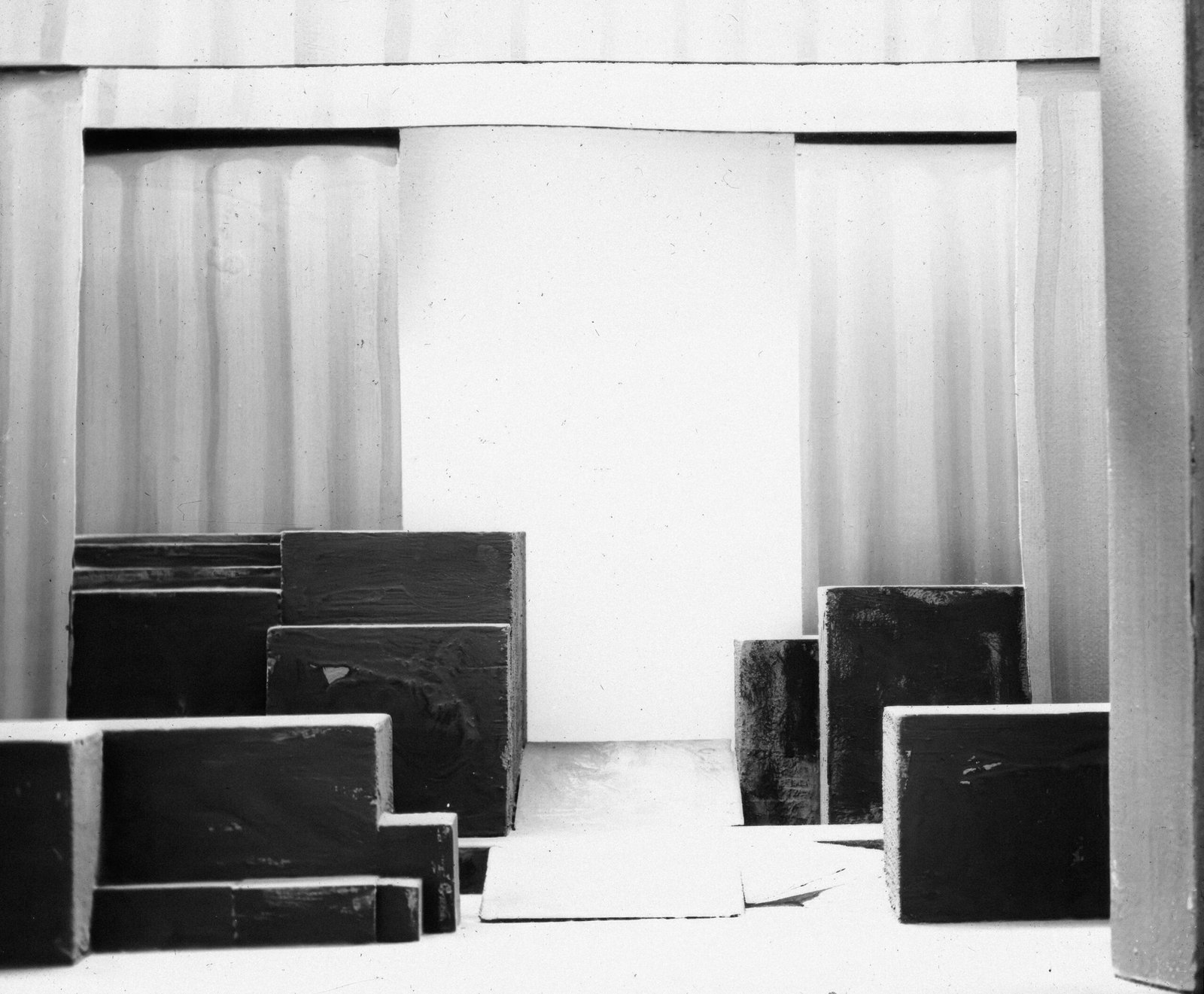 a black and white photo of a room filled with boxes